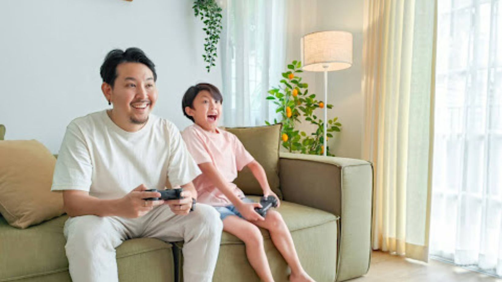 A person and a child sitting on a couch